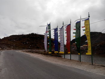 View of empty road against cloudy sky