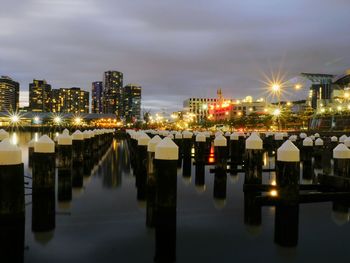 Illuminated cityscape against sky at night