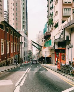 City street and buildings against sky