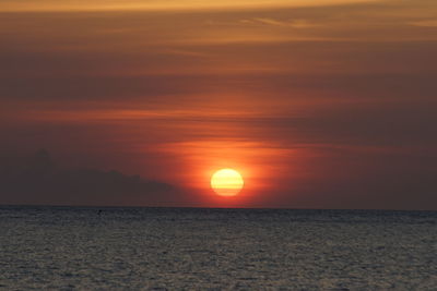 Scenic view of sea against romantic sky at sunset