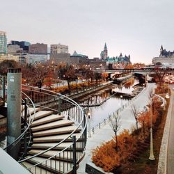 High angle view of canal in city against clear sky during autumn