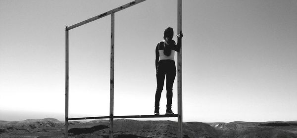 Full length of woman standing on wall