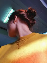 Low angle view of woman wearing yellow casual clothing