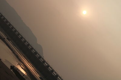 Low angle view of bridge against sky during sunset