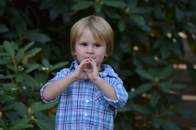 Portrait of cute boy holding leaf