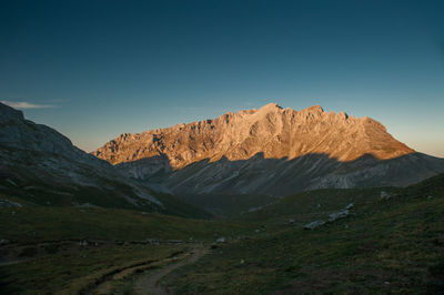 Scenic view of mountains against clear blue sky
