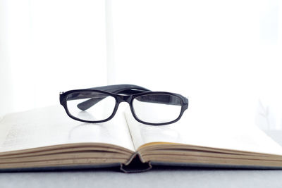 Close-up of eyeglasses on book