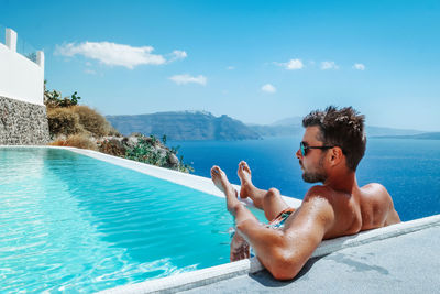 Portrait of young man swimming in pool