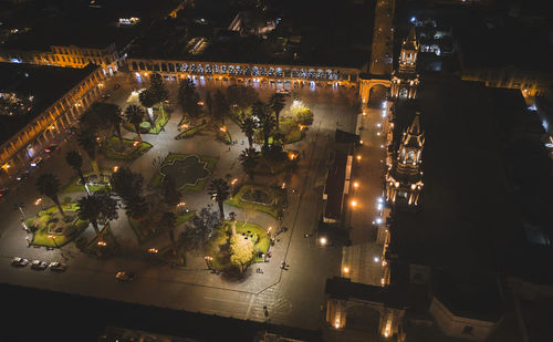 High angle view of illuminated buildings in city at night