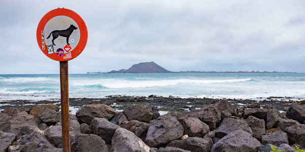 Scenic view of beach by sea against sky