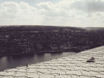 Aerial view of city against cloudy sky