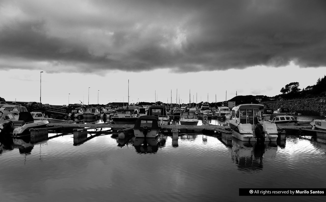 BOATS MOORED ON SEA