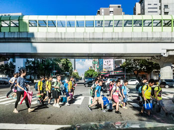 People on bridge in city