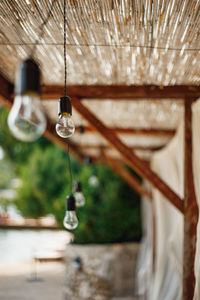 Close-up of lighting equipment hanging on roof