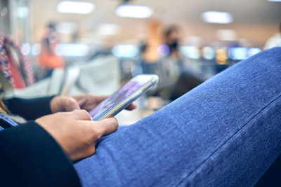 Midsection of woman using mobile phone