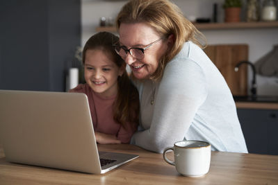 Young woman using laptop at table