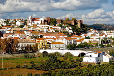 Houses in town against sky