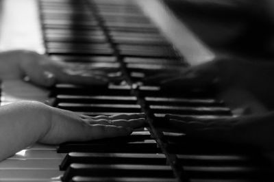 Close-up of man playing piano