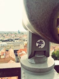 Close-up of coin-operated binoculars against sky