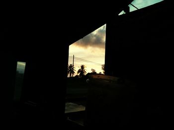 Silhouette of city against sky during sunset