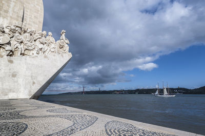 Statue of sea against cloudy sky