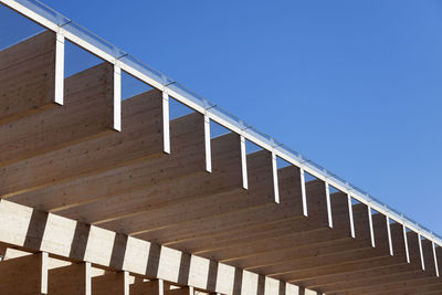 Low angle view of staircase against clear blue sky