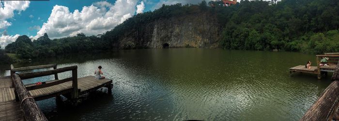 Scenic view of lake by trees against sky