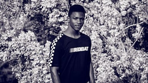 Portrait of smiling young man standing on land