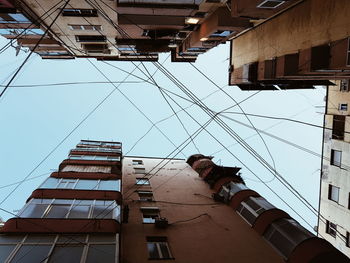 Low angle view of buildings in construction site against sky