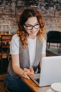 Young woman using laptop at home