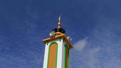 Low angle view of tower against blue sky