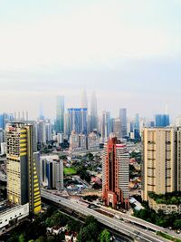 High angle view of modern buildings in city against sky