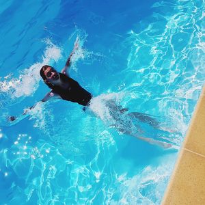 High angle view of girl swimming in pool