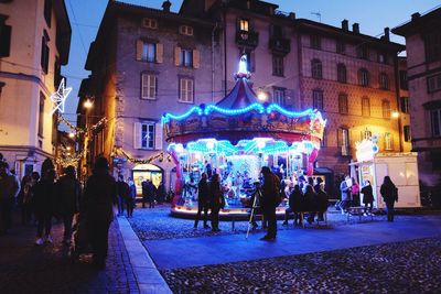 People on street in city at night