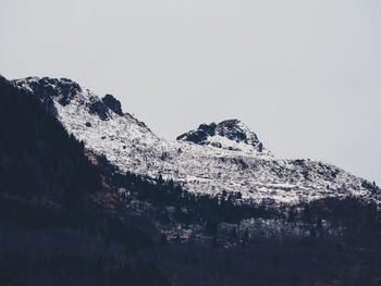 Low angle view of snowcapped mountain against sky