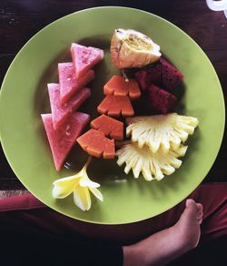 High angle view of chopped fruits in plate on table