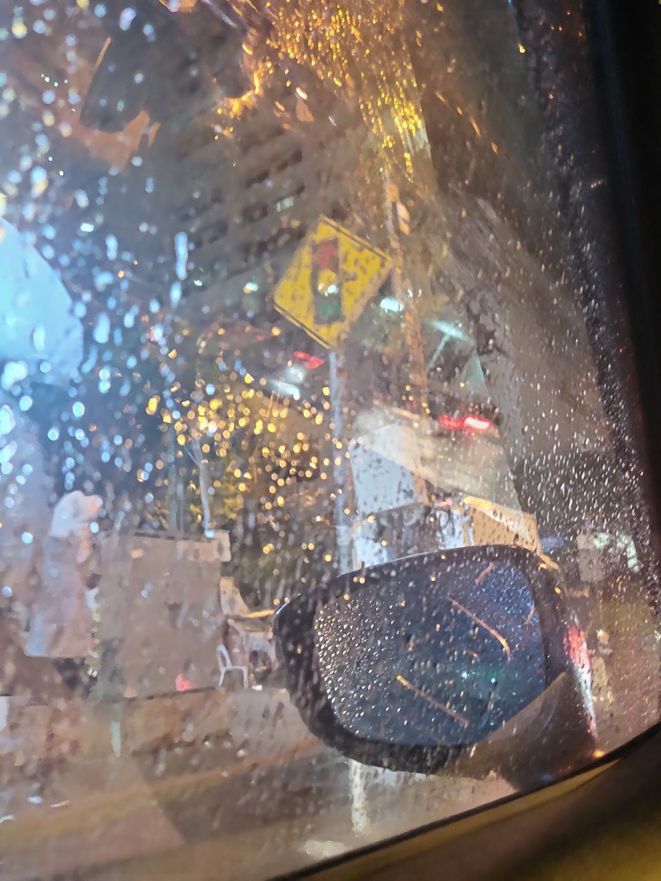 RAINDROPS ON GLASS WINDOW OF CAR