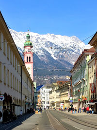 Street amidst buildings against clear blue sky , view out of the city of innsbruck 