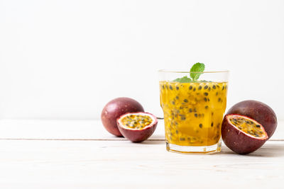 Close-up of fruits on table against white background