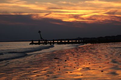 Scenic view of beach against sky during sunset