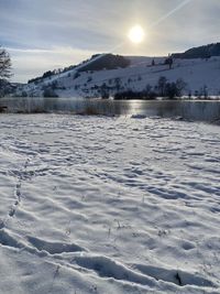 Scenic view of frozen lake against sky during winter