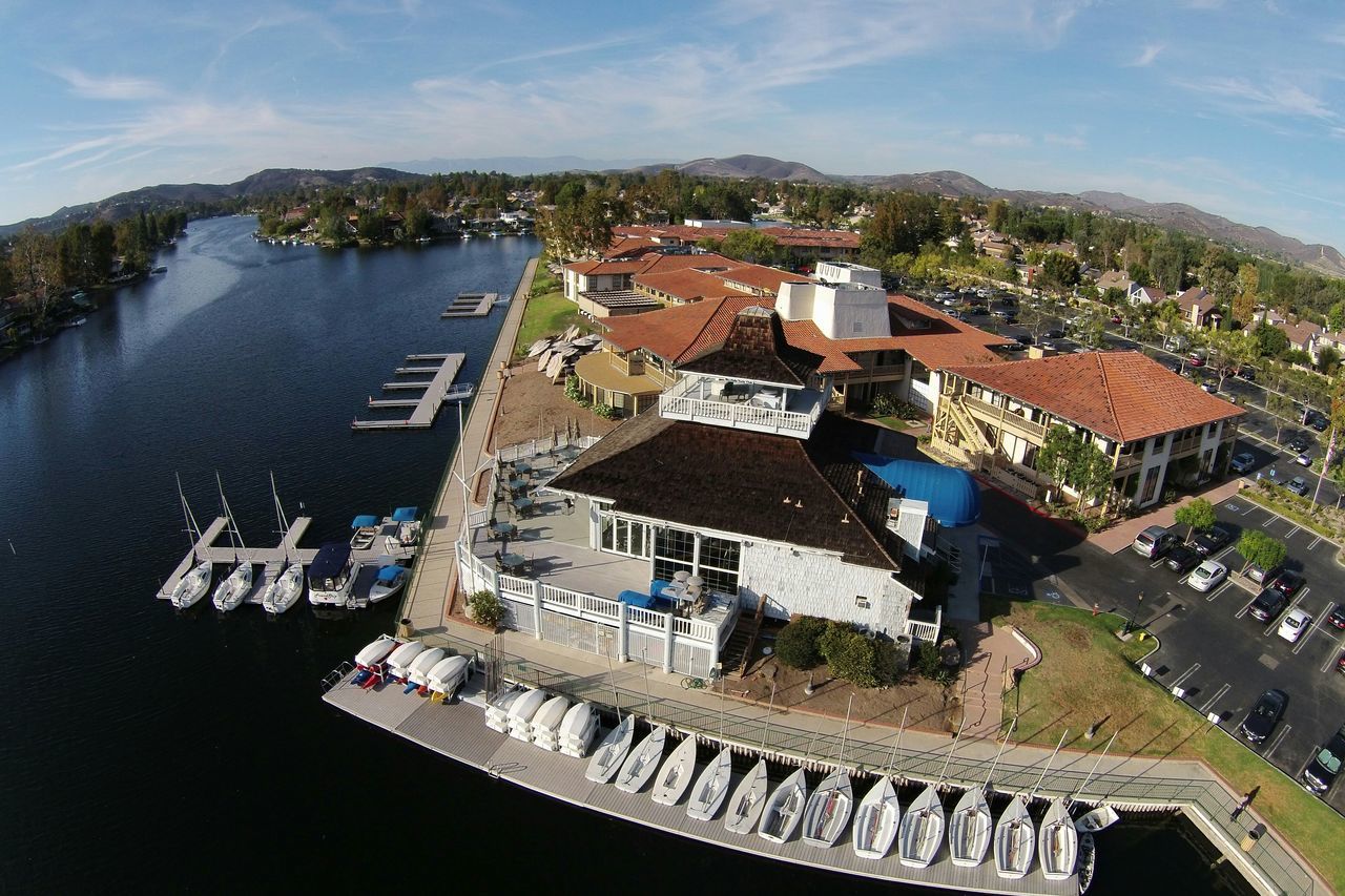 building exterior, architecture, built structure, house, residential structure, residential building, water, high angle view, residential district, mountain, sky, town, tree, roof, townscape, city, day, outdoors, no people, lake