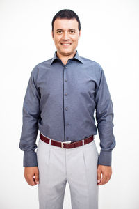 Portrait of smiling man standing against white background