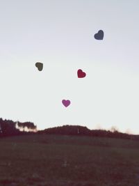 Hot air balloons flying over landscape against sky