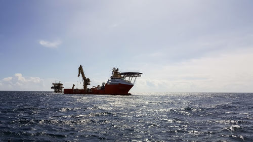 Ship in sea against sky