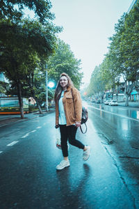 Full length portrait of man standing on road