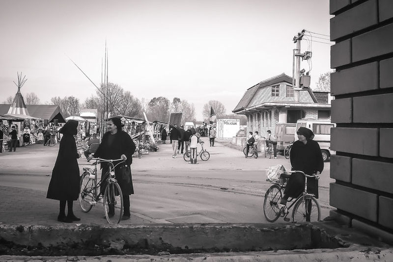 men, building exterior, transportation, architecture, mode of transport, built structure, bicycle, walking, land vehicle, lifestyles, full length, street, person, rear view, clear sky, city, leisure activity, city life, road