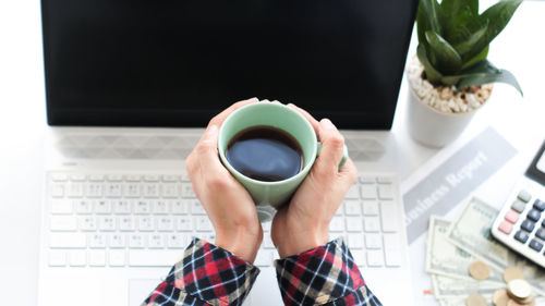Person holding coffee cup