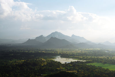 Scenic view of lake and mountains against sky