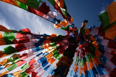 Low angle view of multi colored flags hanging against sky. buddhist prayer flags 